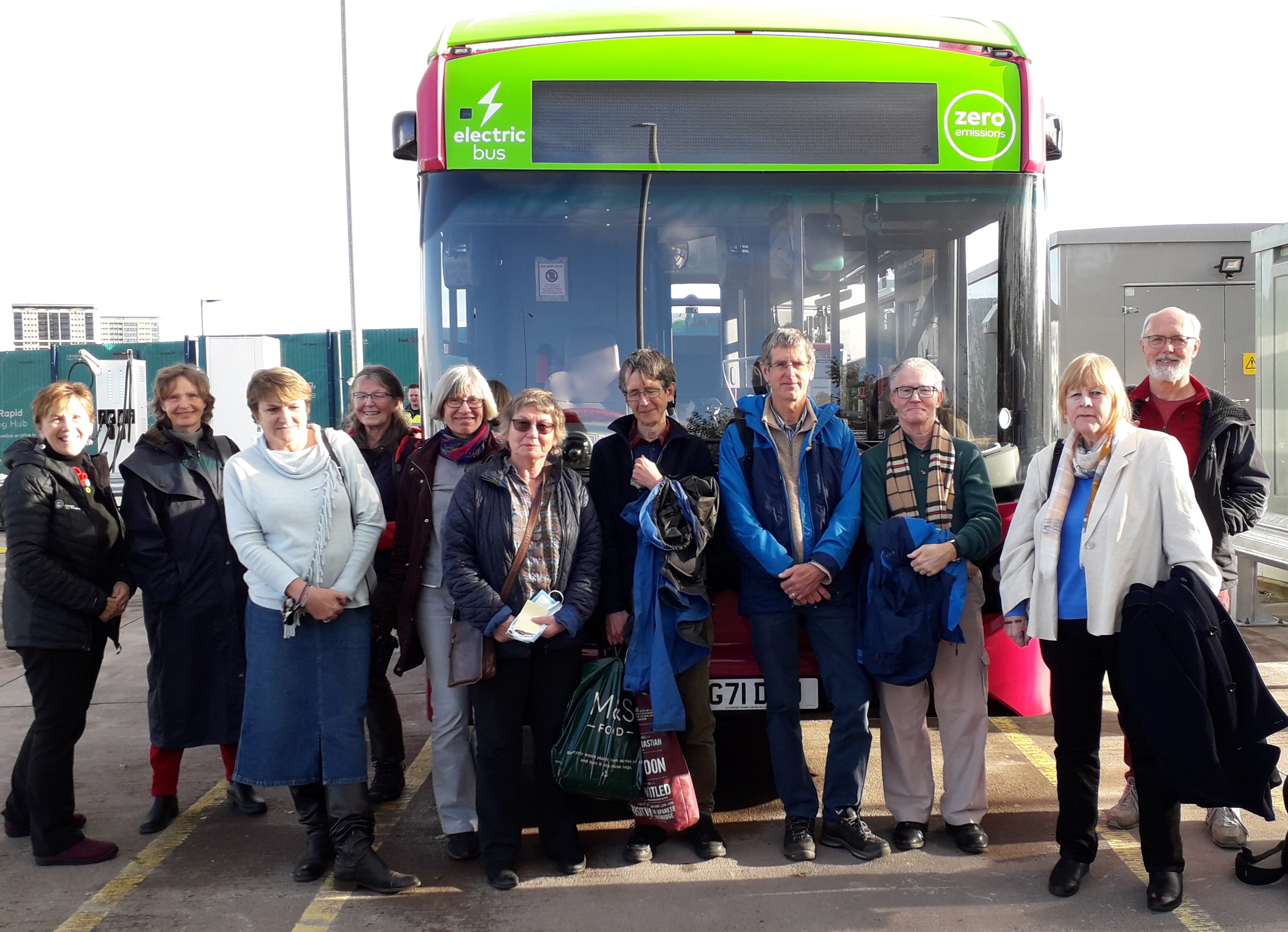 u3a members standing in front of electric bus at COP 26