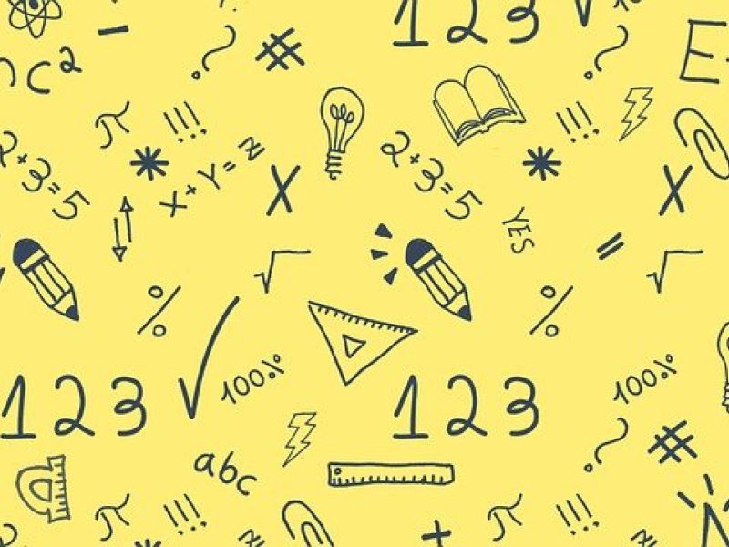 yellow background with drawn on equations etc on top