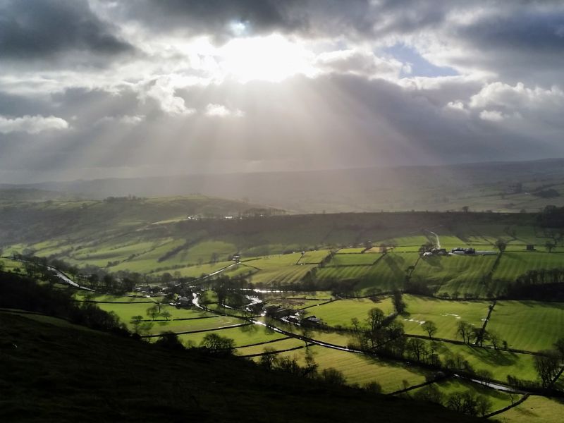 Photo of the sun breaking through clouds over the Dove Valley